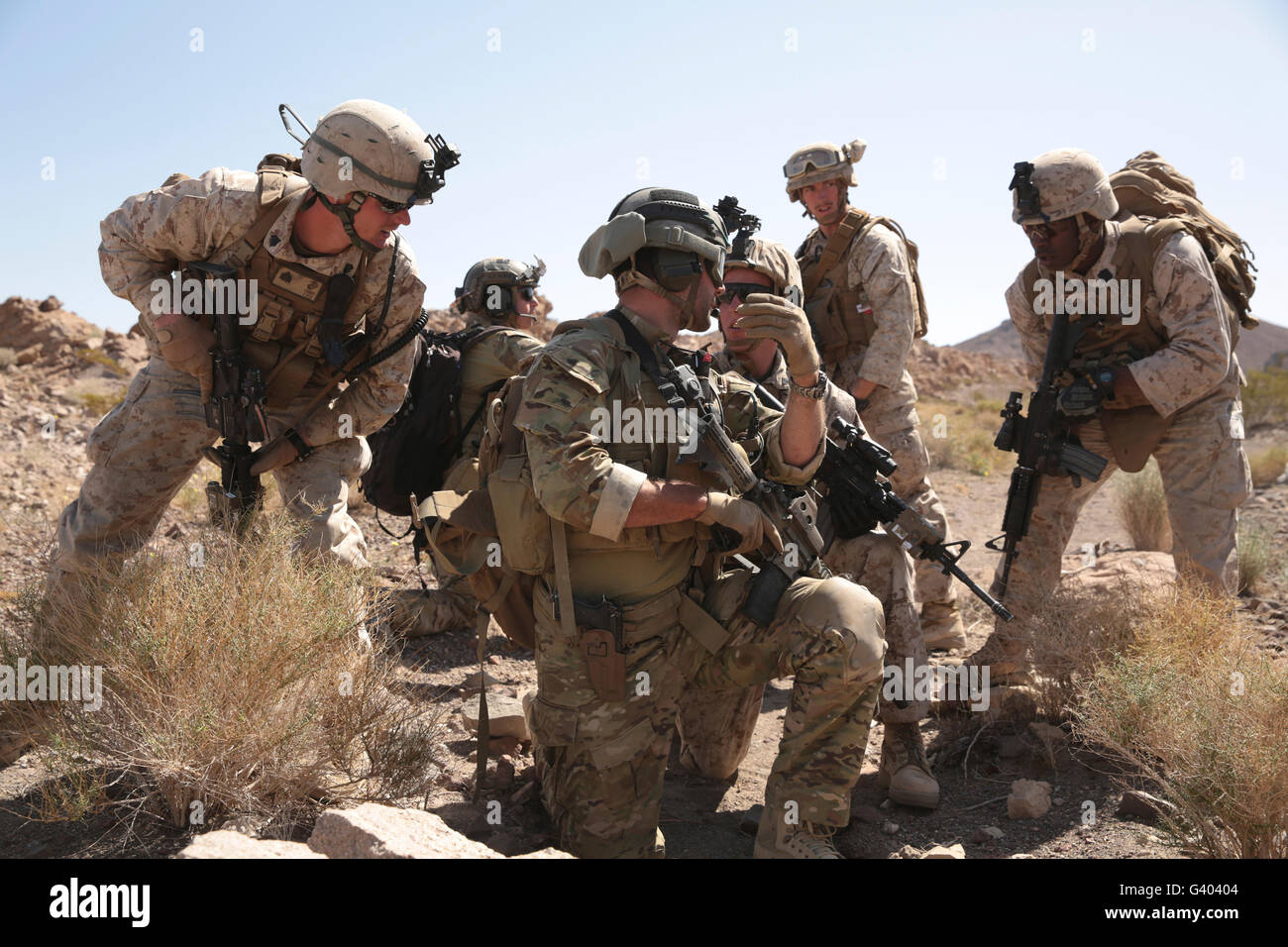 Soldiers discuss strategy during a tactical recovery exercise. Stock Photo