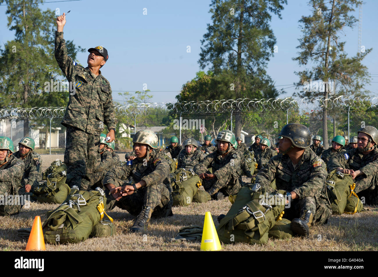 A Honduran Jumpmaster explains actions to conduct during a static line jump. Stock Photo