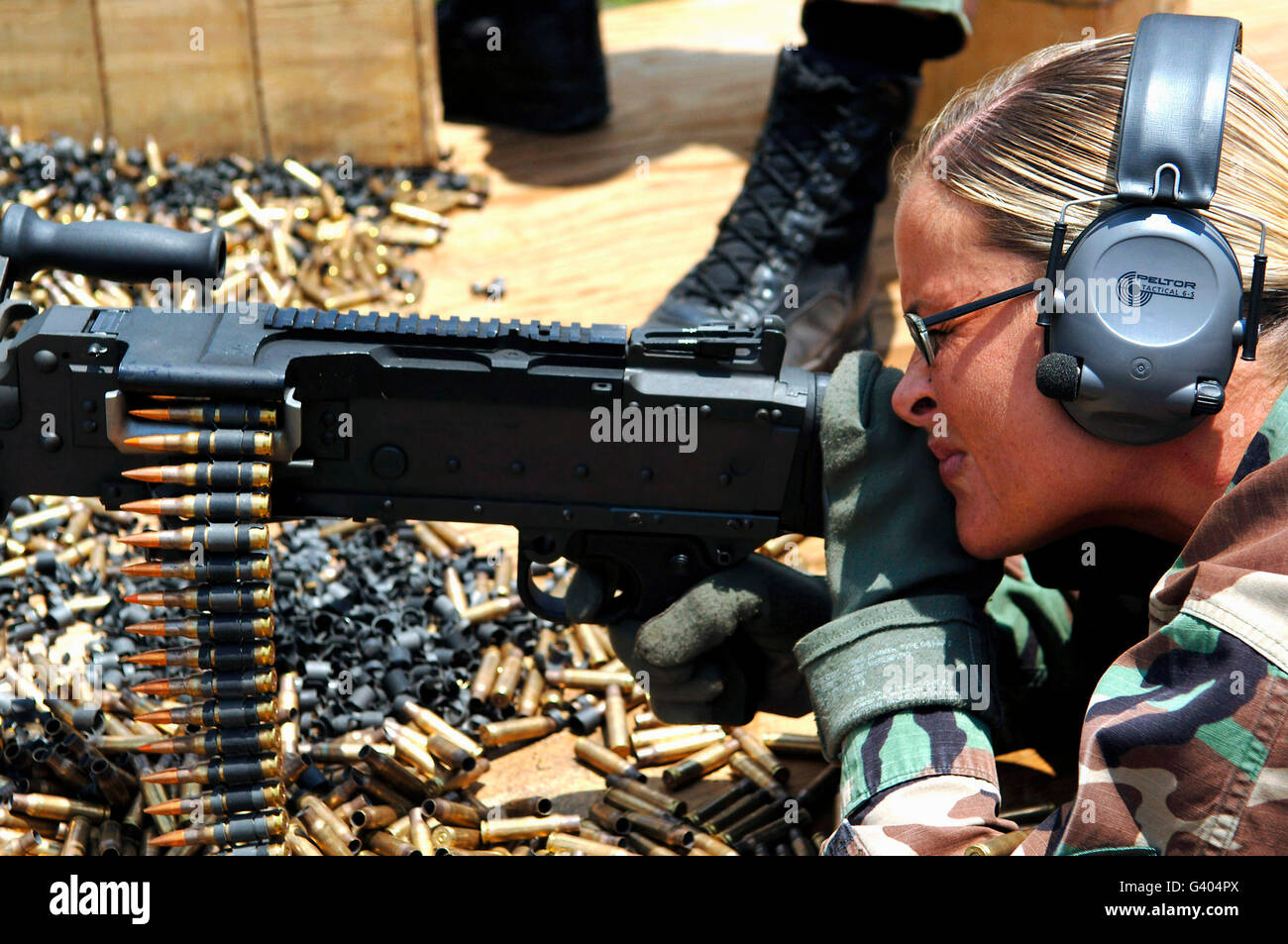 A soldier fires an M240B medium machine gun. Stock Photo
