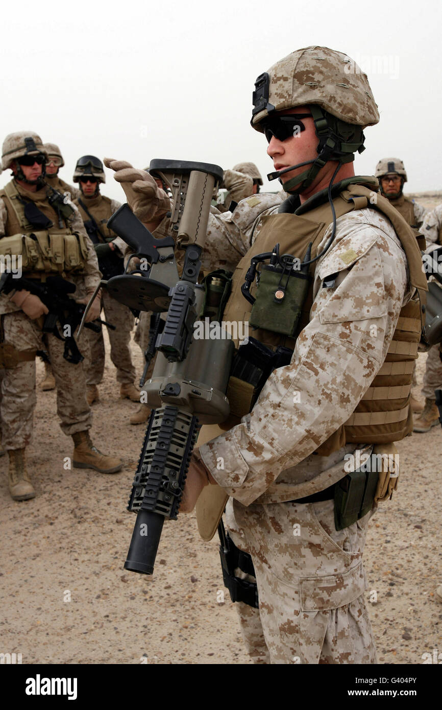 A marine demonstrates loading and unloading procedures for the M-32 ... image.