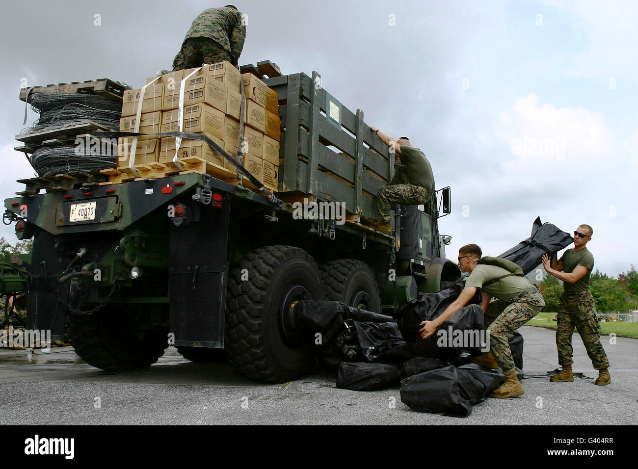 Marines offload tents from a seven-ton truck. Stock Photo