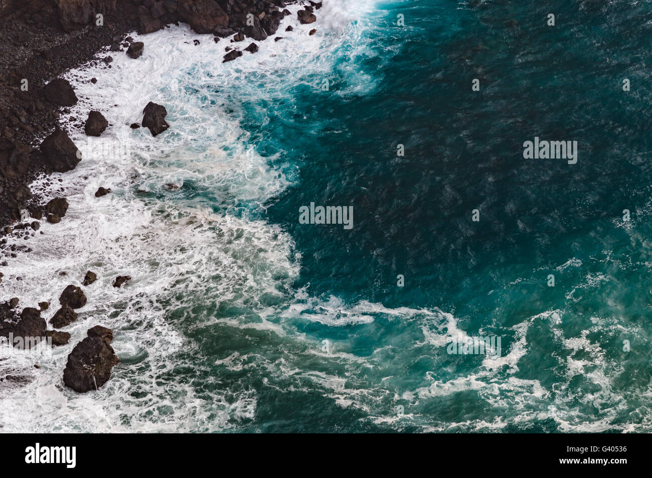 Danger rocky coast, stormy weather with large waves, from above view Stock Photo