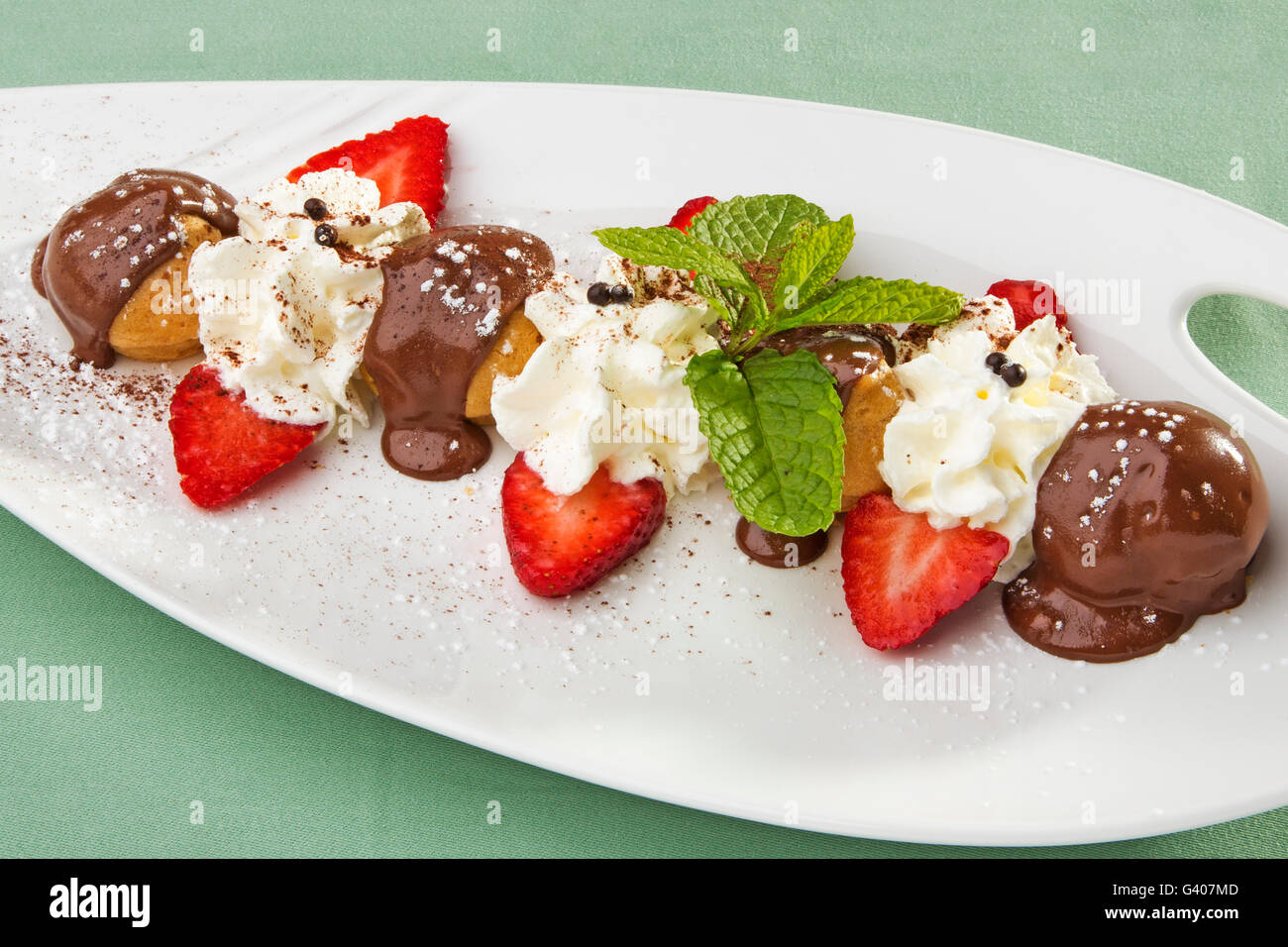 Dessert. Profiteroles with chocolate sauce, cream and fresh