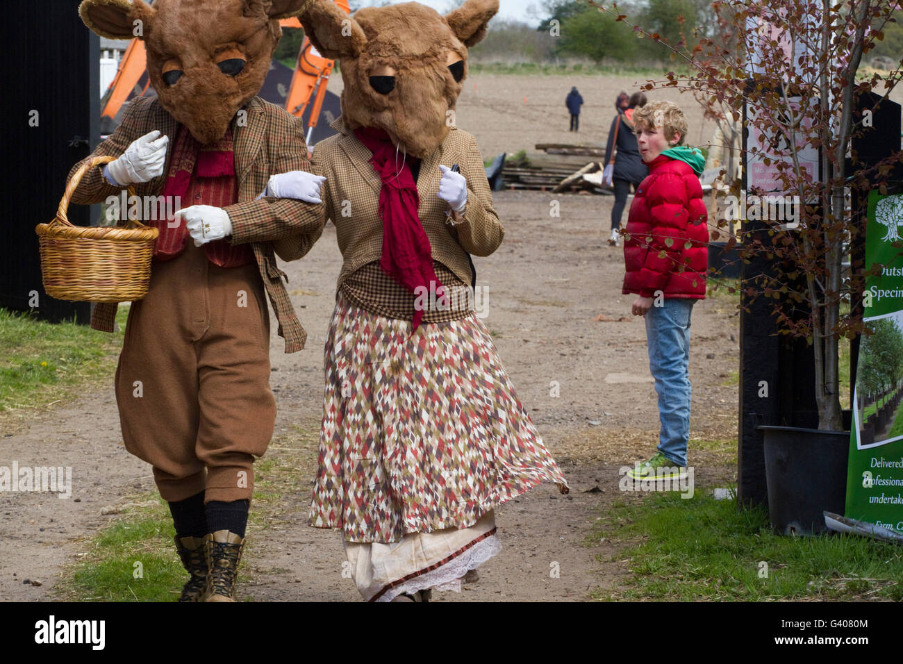 Boy doesn't know what to make of two actors in period mouse costumes at the Alde Valley Spring Festival Stock Photo