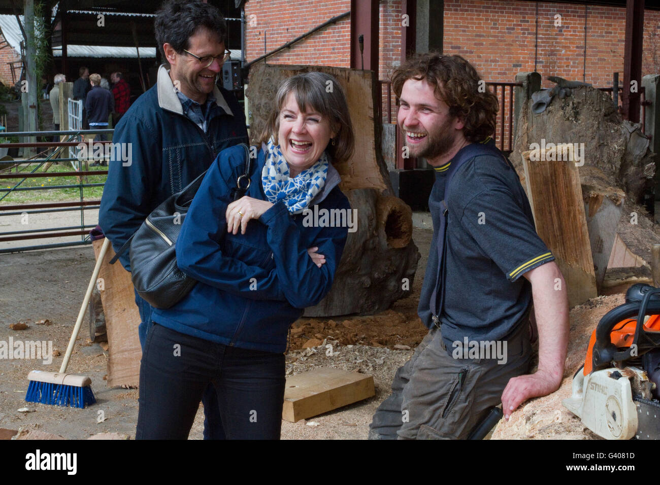 Sculptor Alex Johnson laughing with friends at the Alde Valley Spring Festival Stock Photo