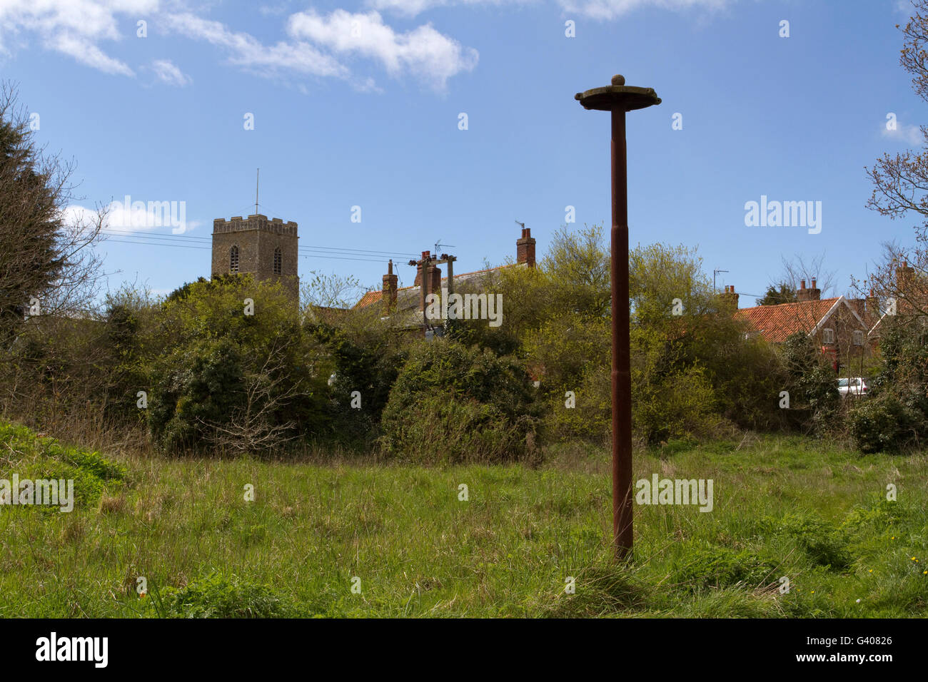 A rusty mysterious pole in a Suffolk village that possibly is disused children's play equipment Stock Photo