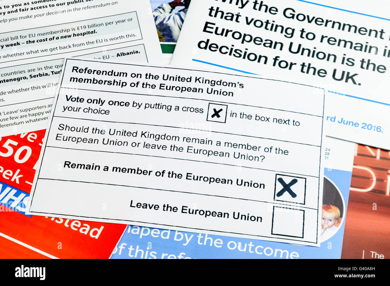 UK Referendum voting slip with a vote to remain as a member of the European Union on top of campaign literature from both the 'leave' (Brexit) and 'remain' (Bremain) camps (mock voting slip) Stock Photo