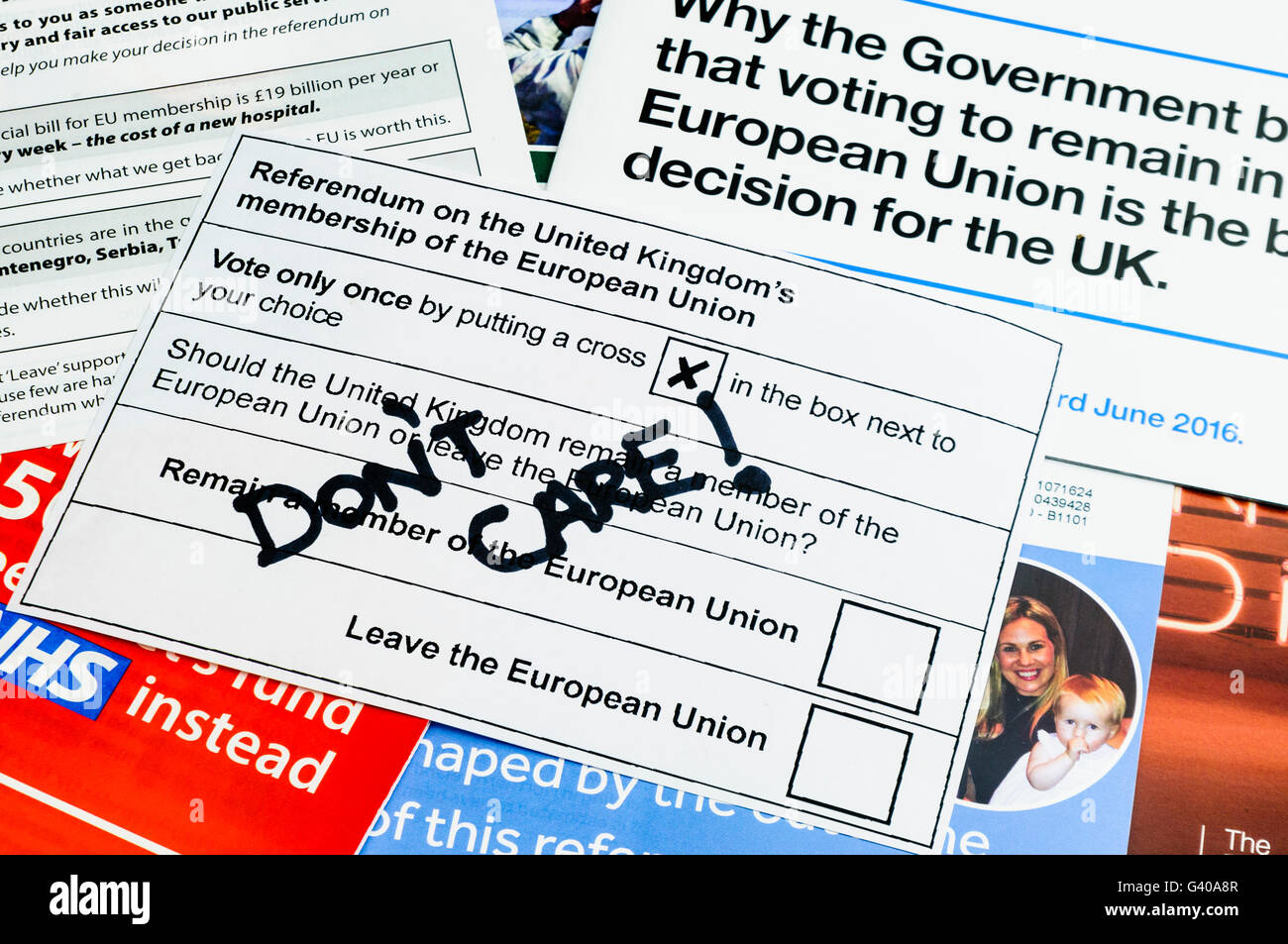 UK Referendum voting slip with 'Don't Care' written on it as a spoiled vote of apathy on top of campaign literature from both the 'leave' (Brexit) and 'remain' (Bremain) camps (mock voting slip) Stock Photo