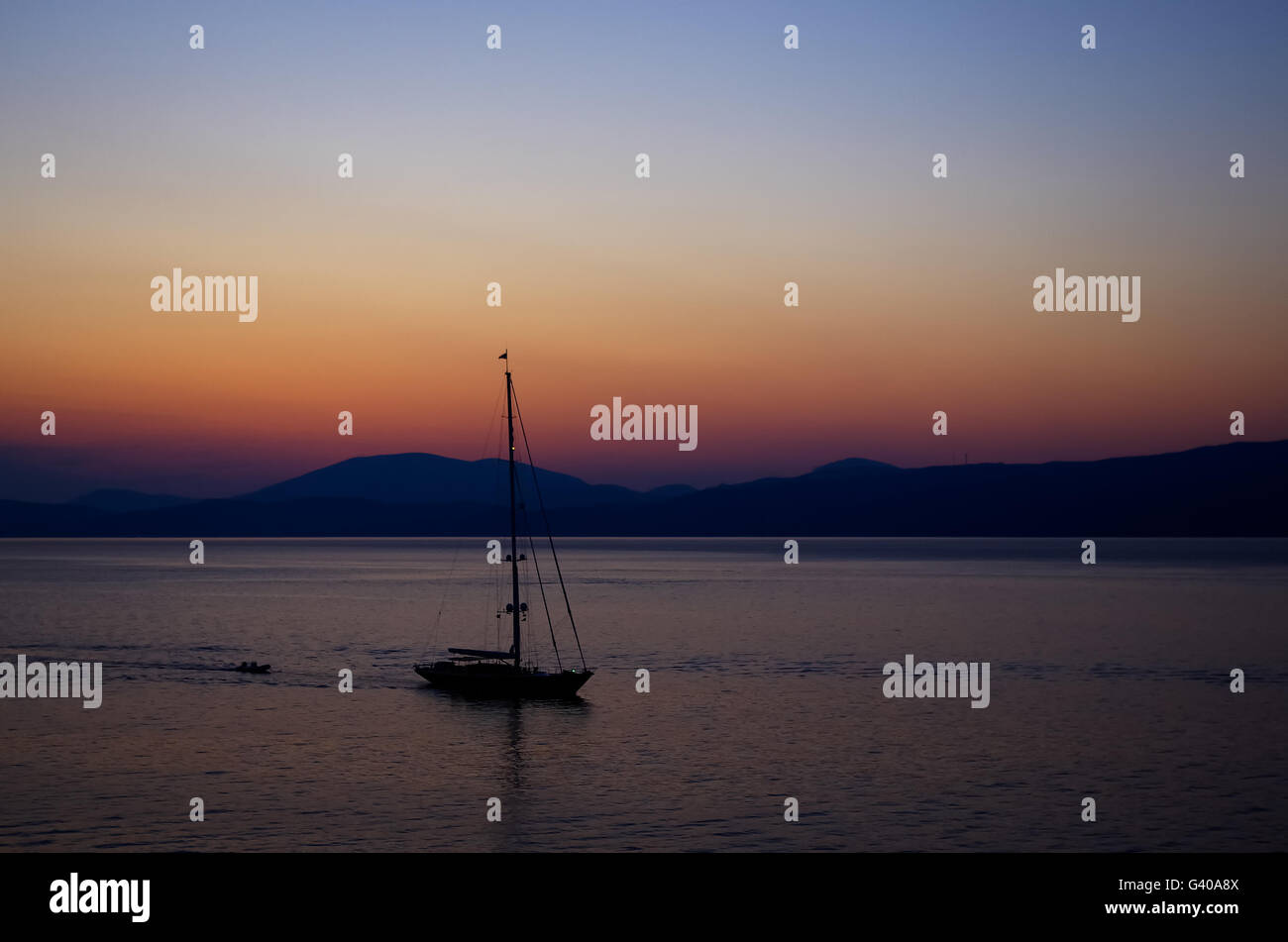 Sailing yacht at dusk in the Aegean sea Stock Photo - Alamy