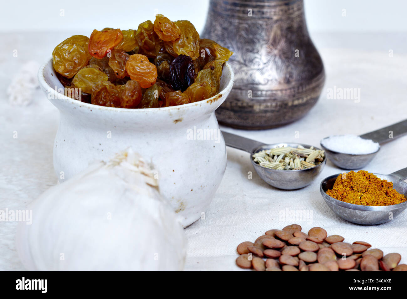 Ingredients for Indian cuisine including salt, curry powder, raisins