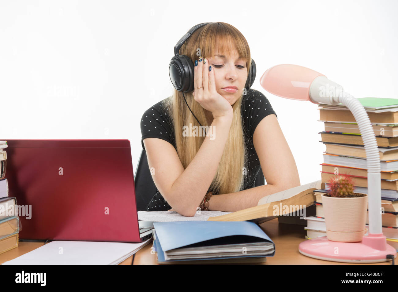 Student falling asleep reading a reference book Stock Photo Alamy