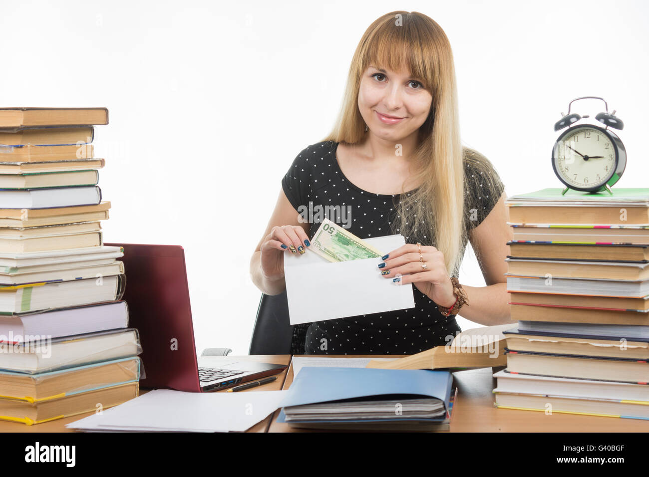 The girl puts money in an envelope to bribe the teacher in the exam, and looked into the frame Stock Photo
