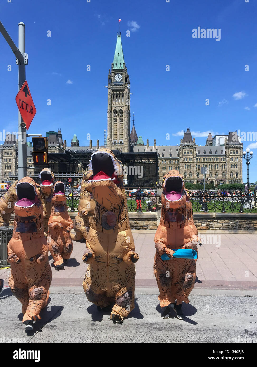 Ottawa, Canada - June 15, 2016:  People dressed as dinosaurs visited Parliament Hill in order to promote a Dinosaur exhibit Stock Photo