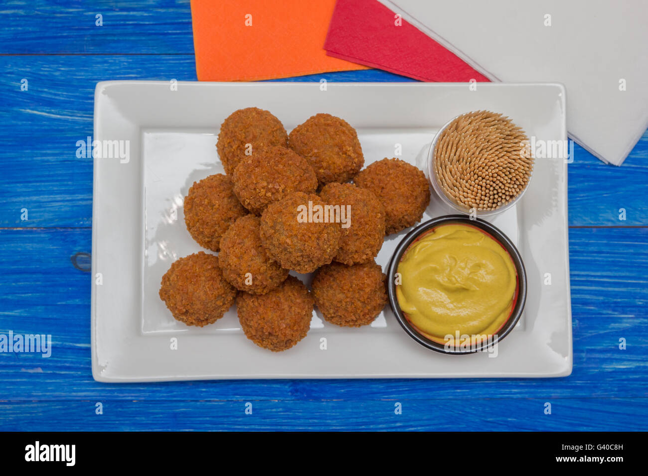 Dutch snack bitterballen with mustard on a white plate Stock Photo