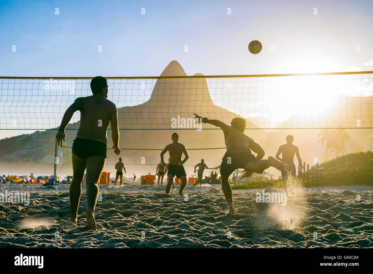 RIO DE JANEIRO - MARCH 27, 2016: Brazilians play futevôlei (footvolley, a sport combining football/soccer and volleyball). Stock Photo