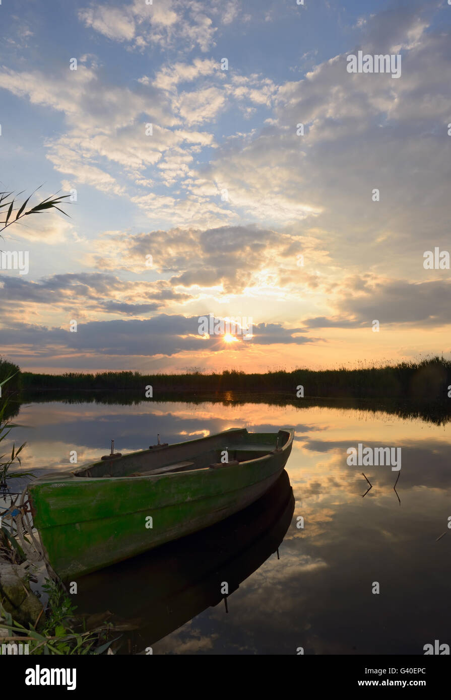 fisherman boat at sunset in summer time Stock Photo