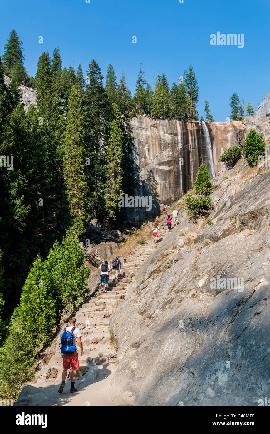 Young man on hiking trail to Vernal Fall, waterfall, Mist Trail, Yosemite Valley, Yosemite National Park Stock Photo