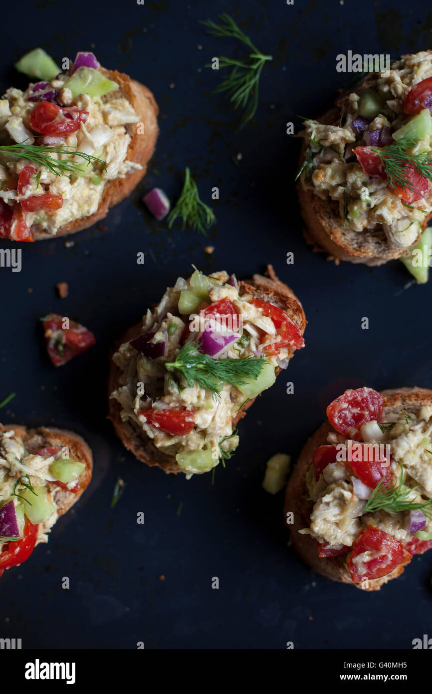Chicken avocado salad with fresh dill on toast for a light lunch or appetizer Stock Photo
