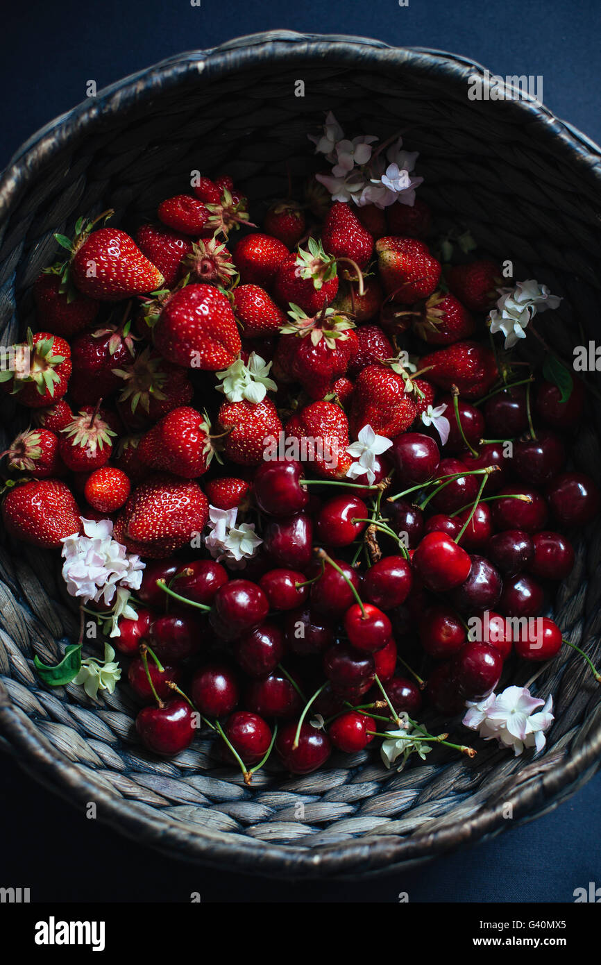 Cherries and strawberries in a basket Stock Photo