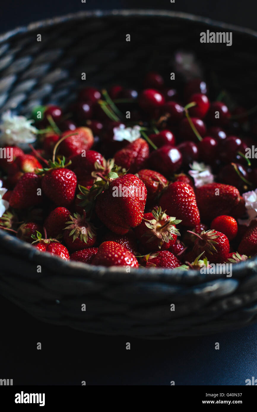 Cherries and strawberries in a basket Stock Photo