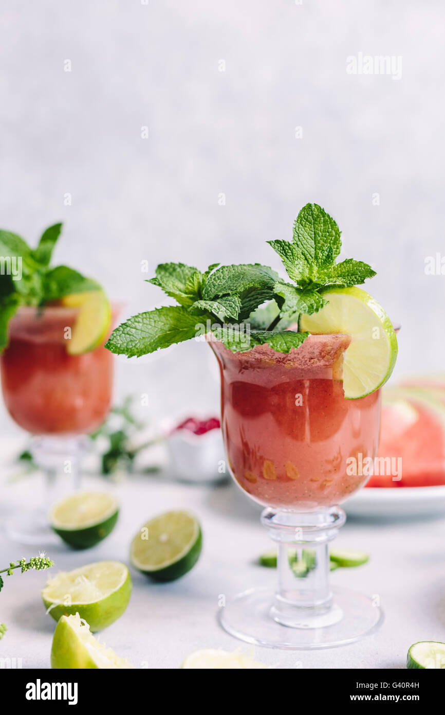 Two glasses of Minty Watermelon Cucumber Smoothie are photographed from the front view. Stock Photo