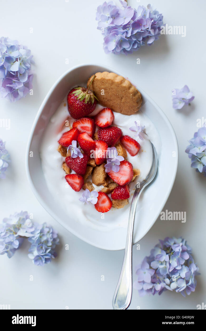 Coconut yogurt with strawberries and crushed coconut cookies Stock Photo