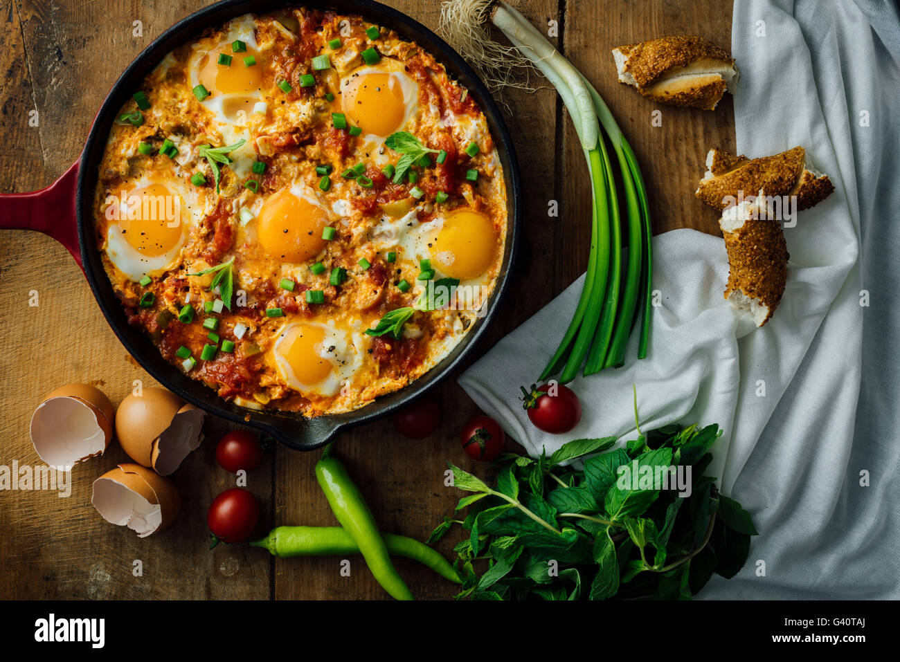 Eggs with tomatoes, green peppers and green onion cooked in a cast iron pan Stock Photo Alamy