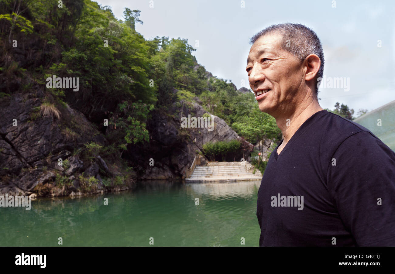 The bust of  a smiling asia middle-aged man Stock Photo