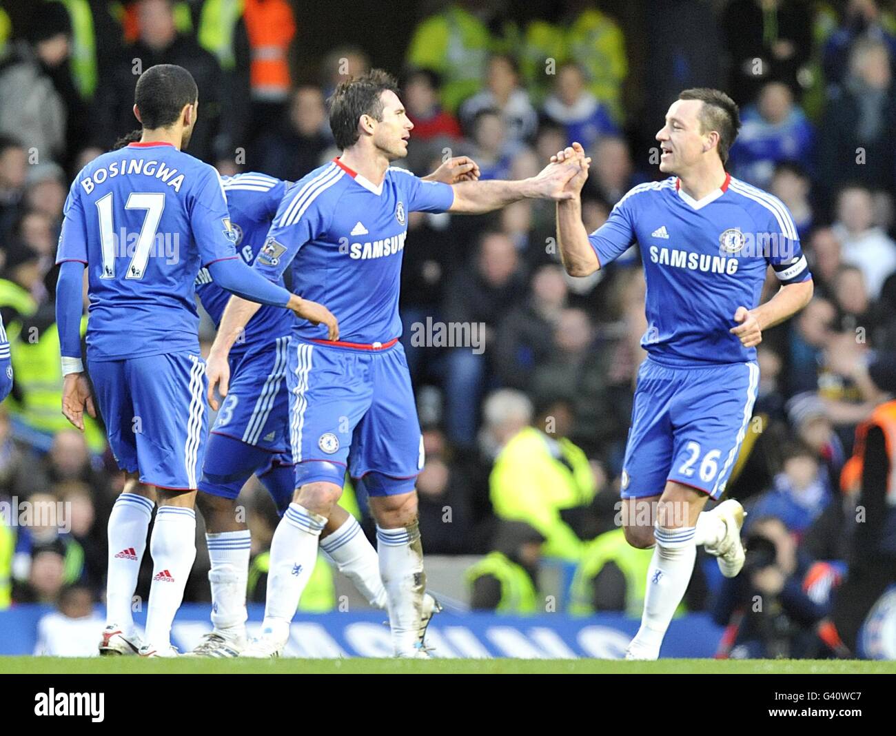 Chelsea captain John Terry (right) celebrates with his team-mates after Ipswich Town's Carlos Edwards scored an own goal to put them 3-0 up Stock Photo