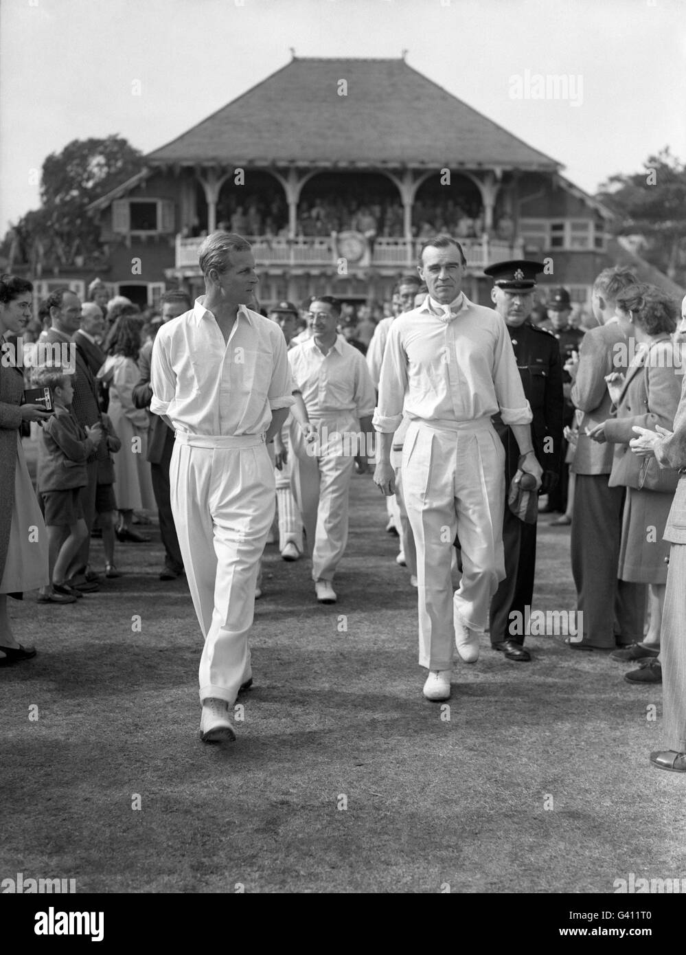 Prince Philip, Duke of Edinburgh walks out on to the pitch at Dean Park, Bournemouth with Errol Holmes for the match between the Duke's County Players Team and Hampshire in a match to aid the National Playing Fields Association. Stock Photo