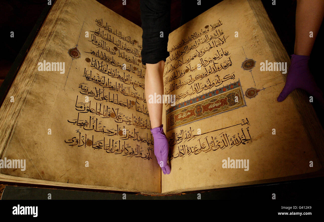 Conservation Intern Elaine Sheldon holds the pages of the Koran of Kansuh al-Ghuri at The University of Manchester's John Rylands Library, Manchester. Stock Photo