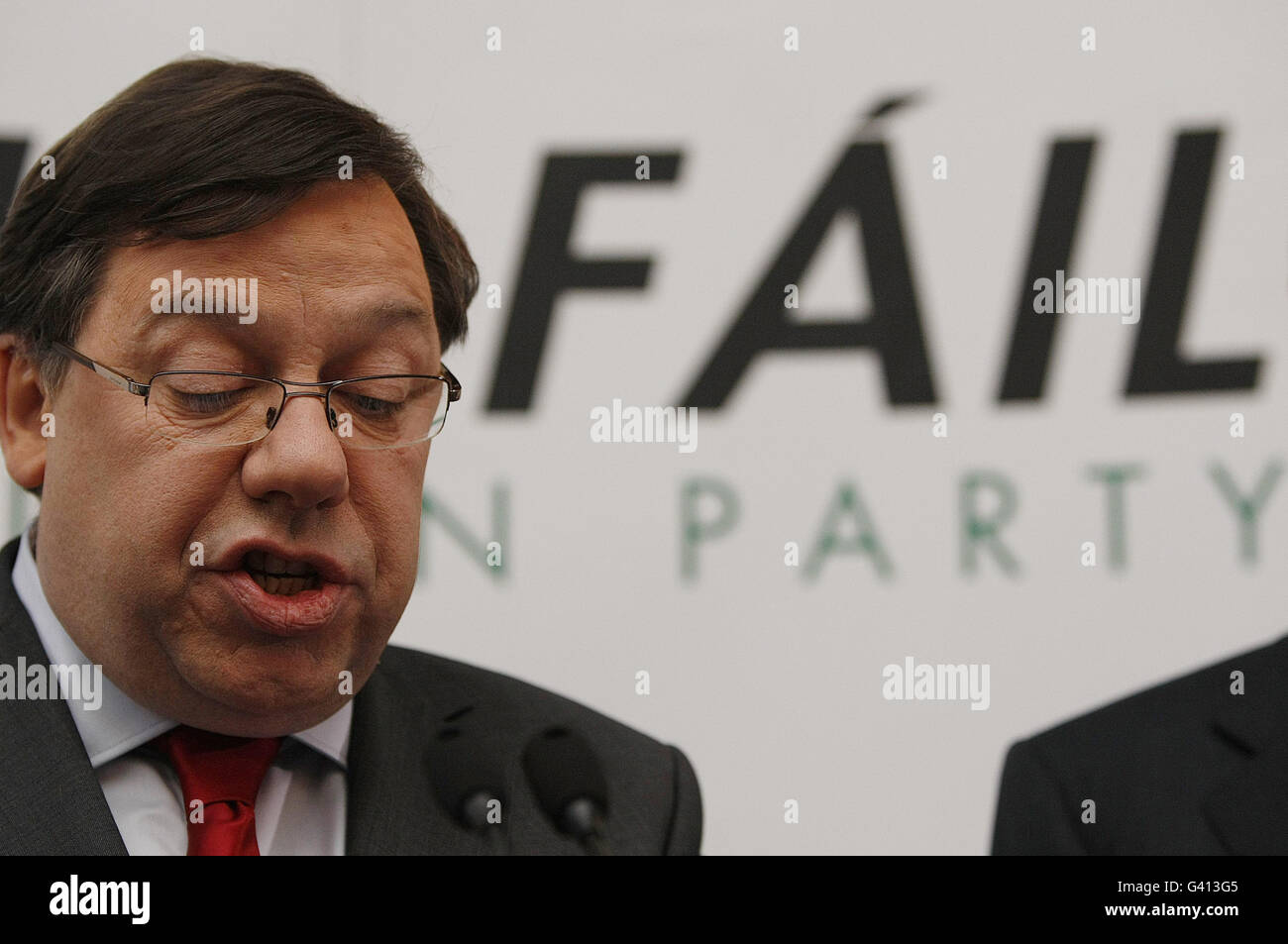 Taoseach Brian Cowen TD (left) announces he is standing down as Fianna Fail Party Leader, during a press conference in the Merrion Hotel Dublin. Stock Photo
