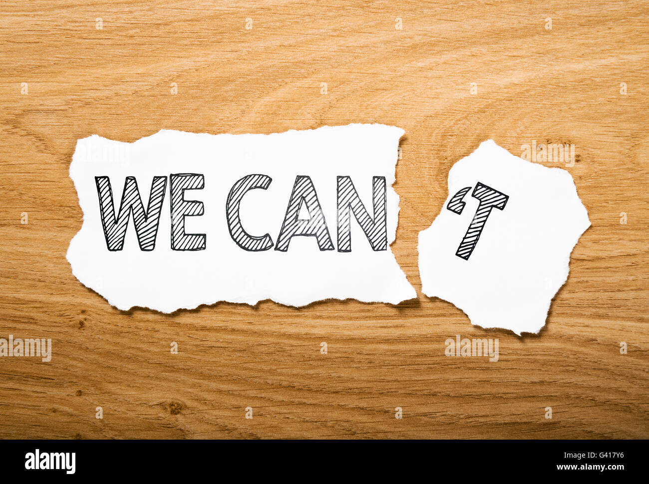 we can or we we can't: two pieces torn paper with contrast messages Stock Photo