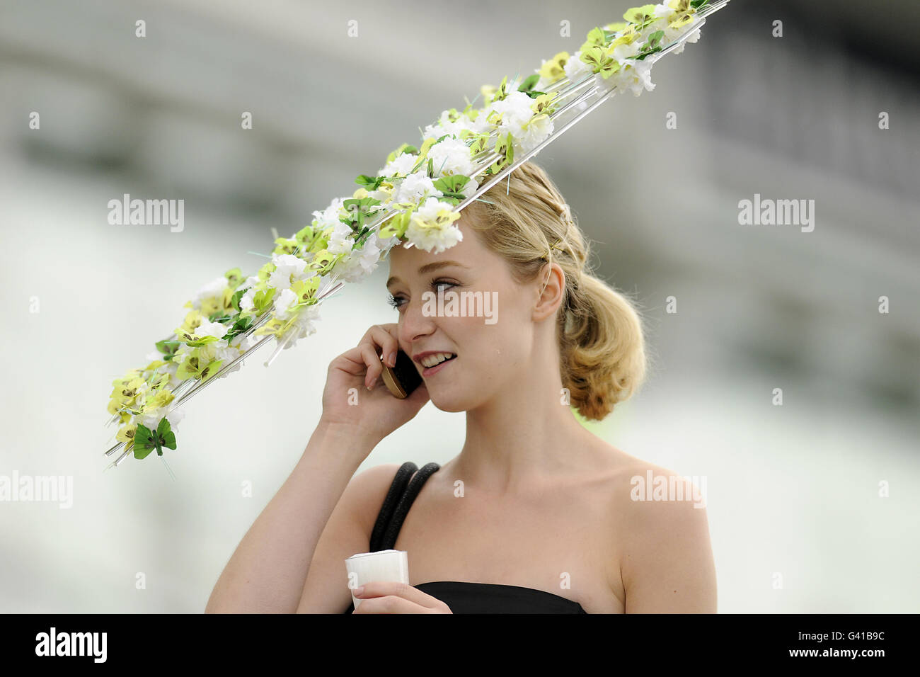 A female recegoer wears a fancy hat during The Investec Ladies Day Stock Photo
