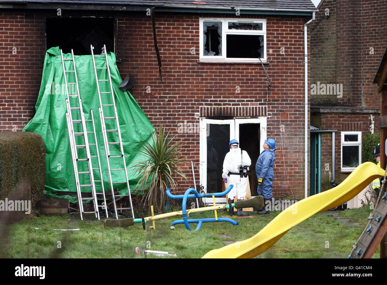 Police and forensic investigators at the property in Hulland Ward, near Ashbourne, Derbyshire where four young children died in a house fire in a village last night. Stock Photo
