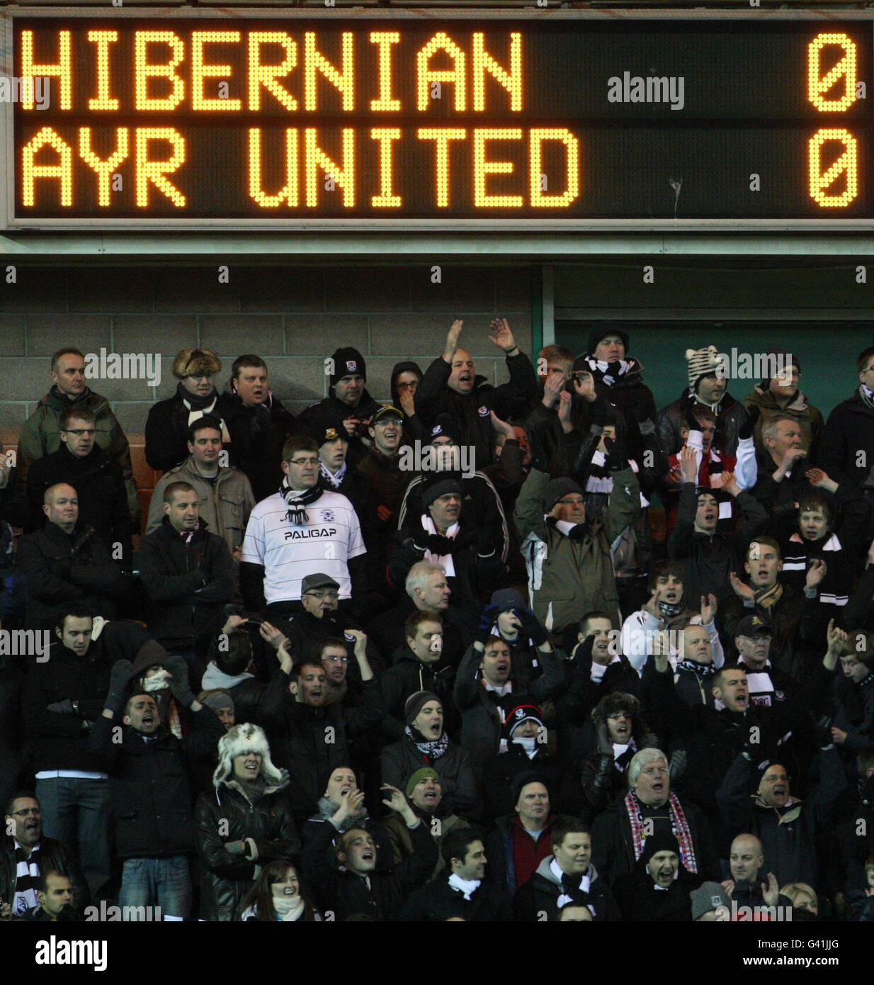 Ayr United fans under the scoreboard reading the final score Stock