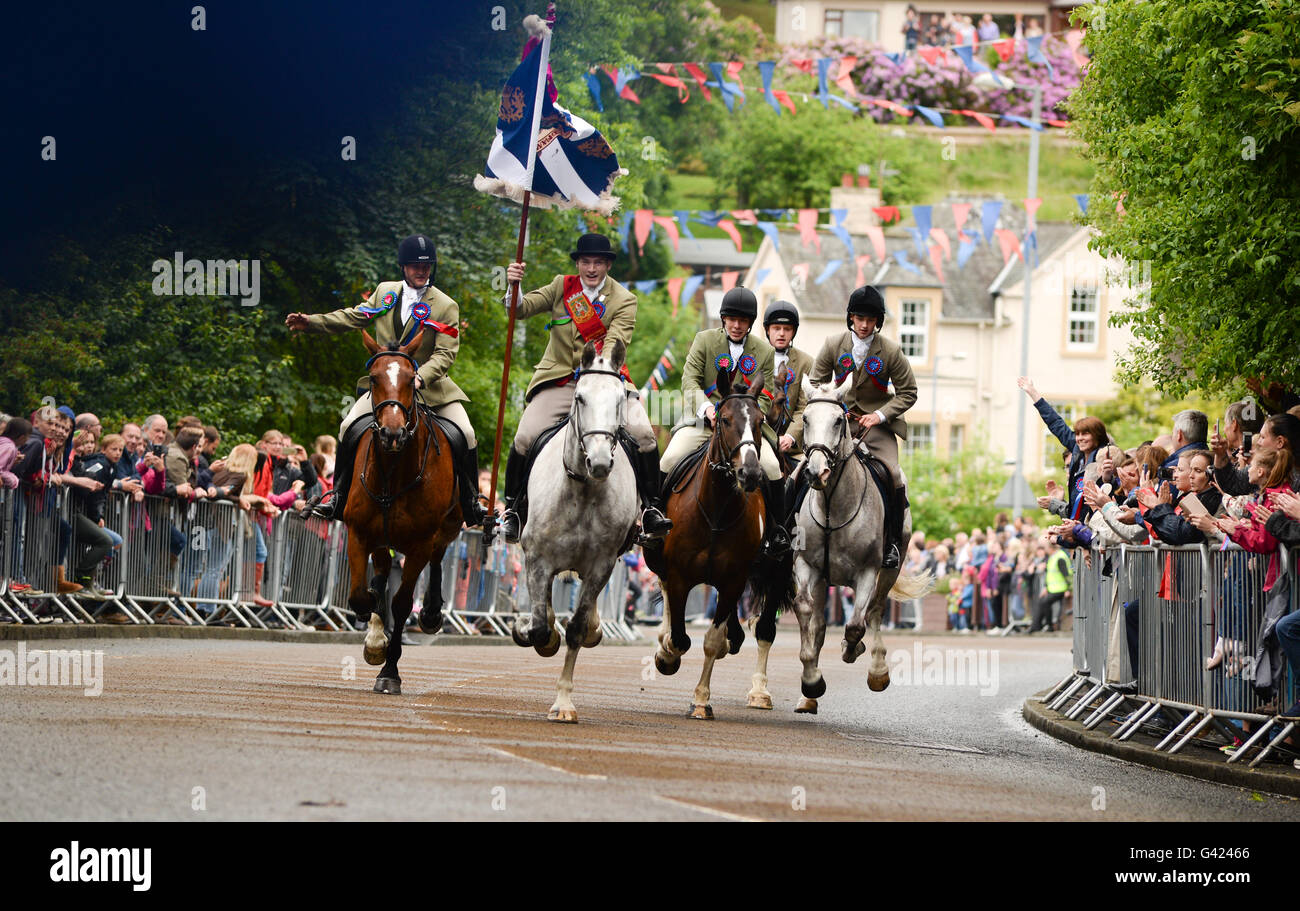 Selkirk, Scottish Borders, UK. 17 Jun 2016.  'The Standard Bearer' Rory Monks leads the cavaclade back to the town having ridden the marches.  Selkirk Common Riding commemorates how, after the disastrous Battle of Flodden in 1513, from the eighty men that left the town, only one – Fletcher - returned bearing a captured English flag. Legend has it that he cast the flag about his head to indicate that all the other men of Selkirk had been cut down. Credit:  Jim Gibson/Alamy Live News Stock Photo