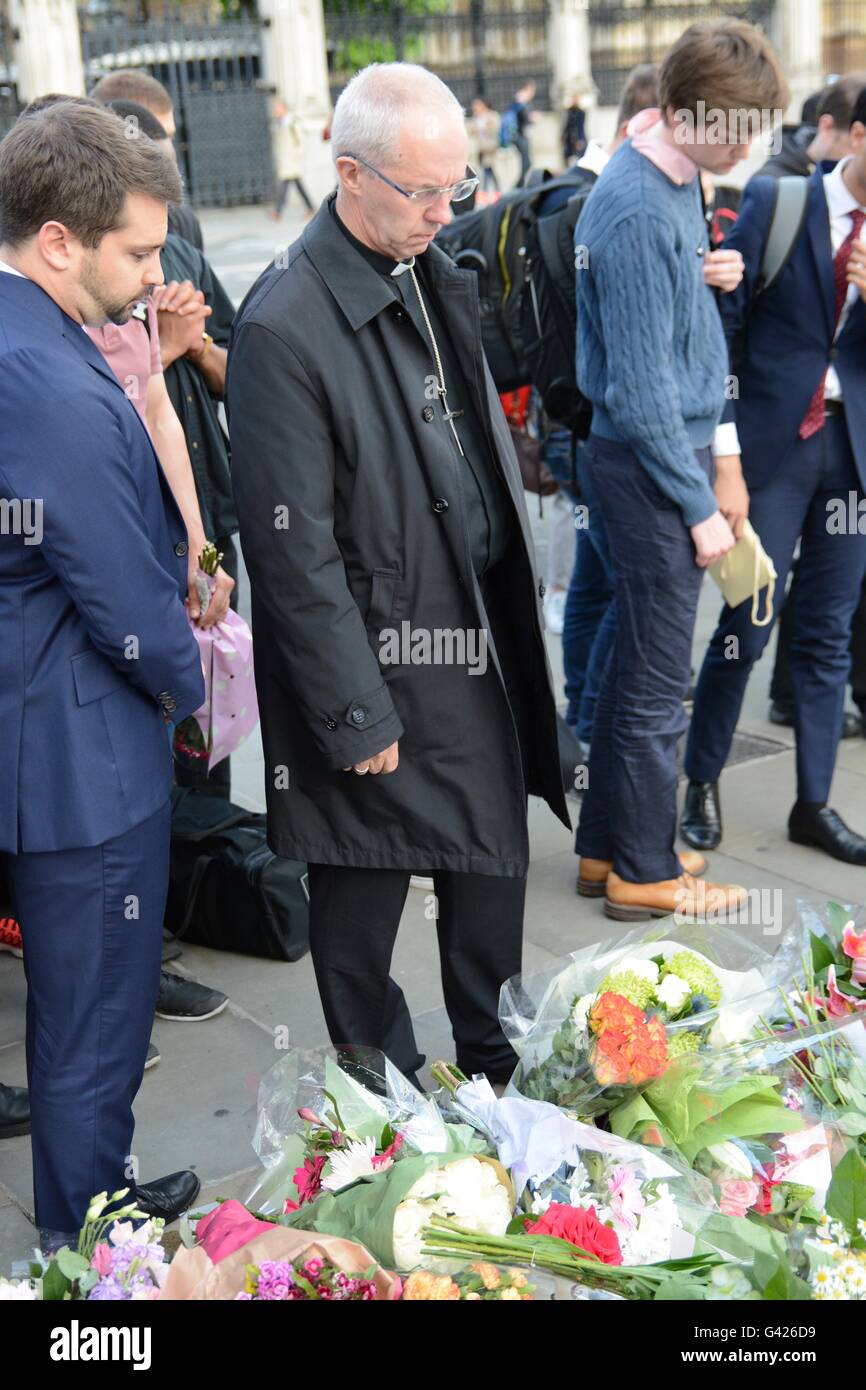 London, England. 17 June 2016. A vicar looks at the flowers left by wellwishers. Credit: Marc Ward/Alamy Live News Stock Photo