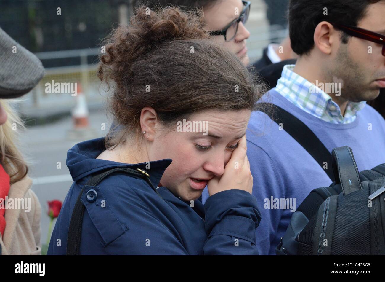 London, England. 17 June 2016. A mourner wipes away a tear as she is overcome with grief following the death of Jo Cox MP. Credit: Marc Ward/Alamy Live News Stock Photo