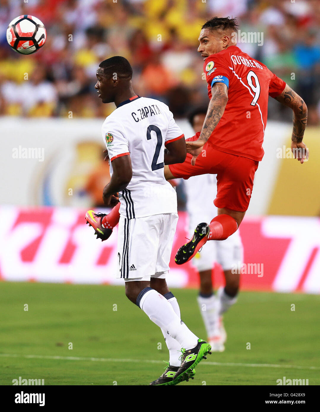 New Jersey, USA. 17th June, 2016. Jose Guerrero (R) of Peru vies with Cristian Zapata of Colombia during their quarterfinal match of 2016 Copa America soccer tournament at the Metlife Stadium in New Jersey, the United States, June 17, 2016. Colombia won in a penalty shootout with 4-2. Credit:  Qin Lang/Xinhua/Alamy Live News Stock Photo
