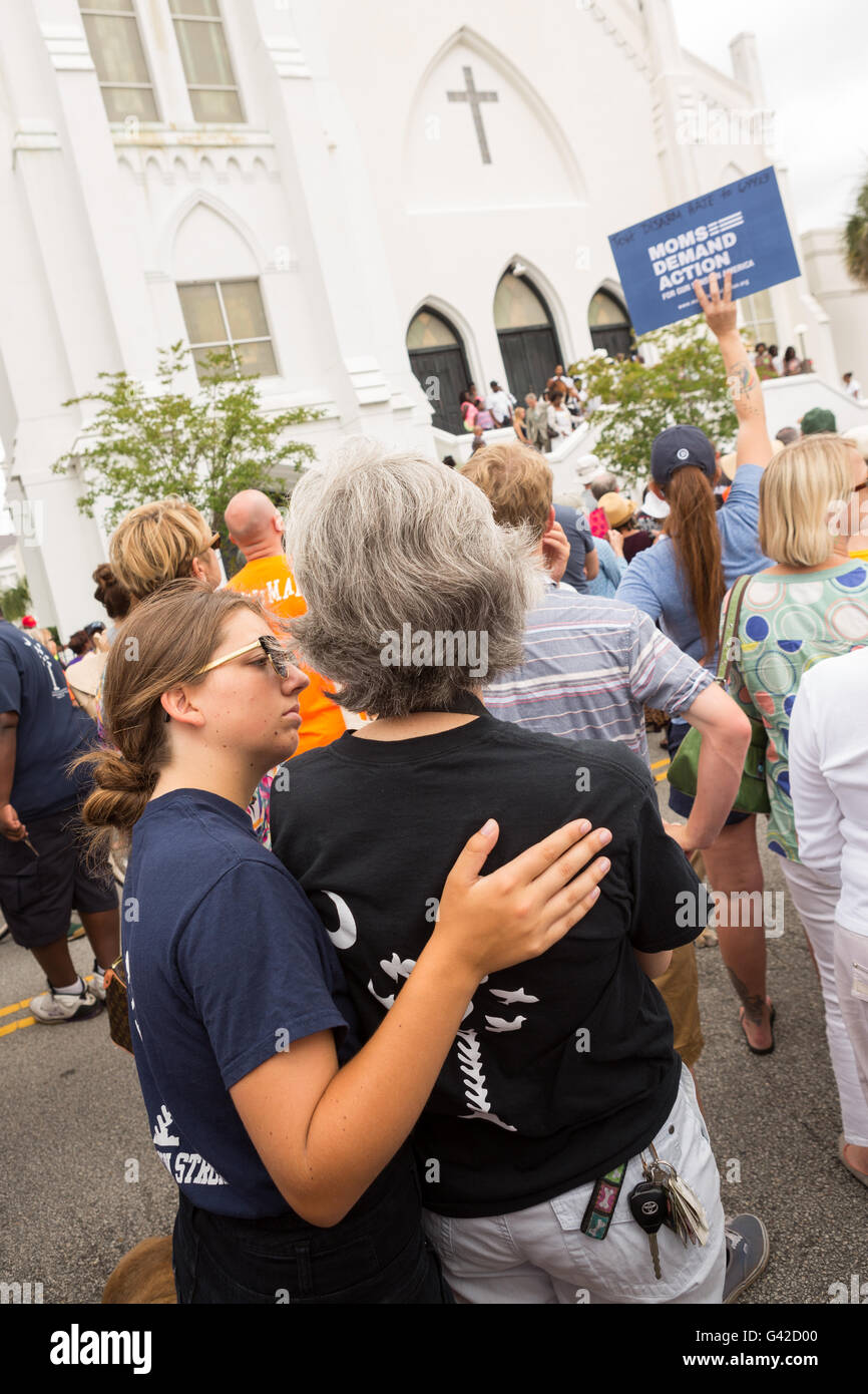 Charleston, United States. 18th June, 2016. Residents embrace during a memorial service for the Charleston Nine outside the Mother Emanuel African Methodist Episcopal Church on the anniversary of the mass shooting June 18, 2016 in Charleston, South Carolina. Nine members of the church community were gunned down during bible study inside the church on June 17, 2015. Credit:  Planetpix/Alamy Live News Stock Photo