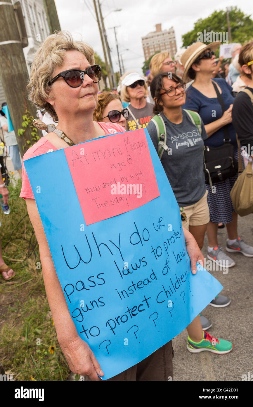 Charleston, United States. 18th June, 2016. A resident holds a sign demanding gun control during a memorial service for the Charleston Nine at the Mother Emanuel African Methodist Episcopal Church on the anniversary of the mass shooting June 18, 2016 in Charleston, South Carolina. Nine members of the church community were gunned down during bible study inside the church on June 17, 2015. Credit:  Planetpix/Alamy Live News Stock Photo
