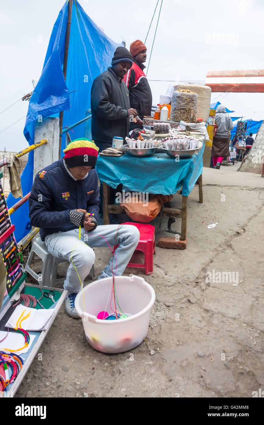 Handwoven bracelet seller and jhaal muri (puffed rice snack) seller at boarding point of Darjeeling Ropeway in West Bengal Stock Photo