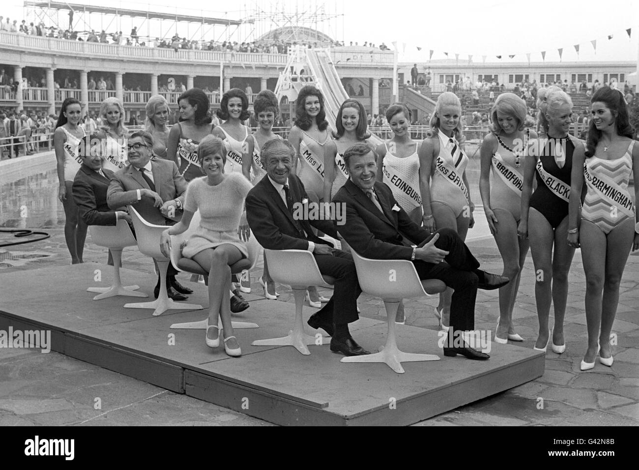 Thirteen girls lined up at Blackpool and one of them will be crowned Miss UK. The judges for this beauty pageant are seated in front of the girls; from the left - Eric Morley, Harry Worth, Cilla Black, Sid James and Val Doonican. Stock Photo