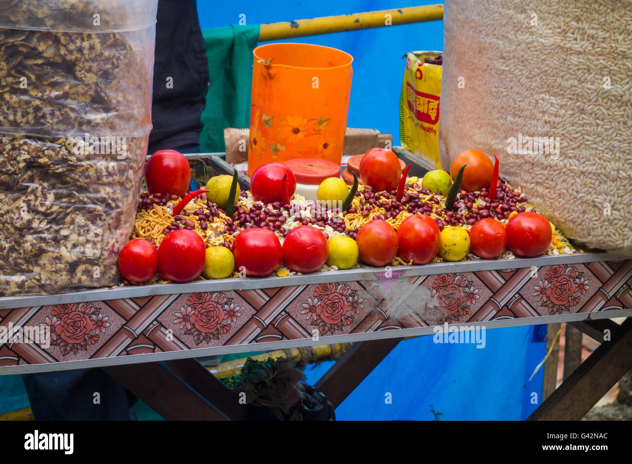 All the ingredients needed for Jhaal Muri ( Puffed Rice Snack ) arranged on table by a seller. Stock Photo