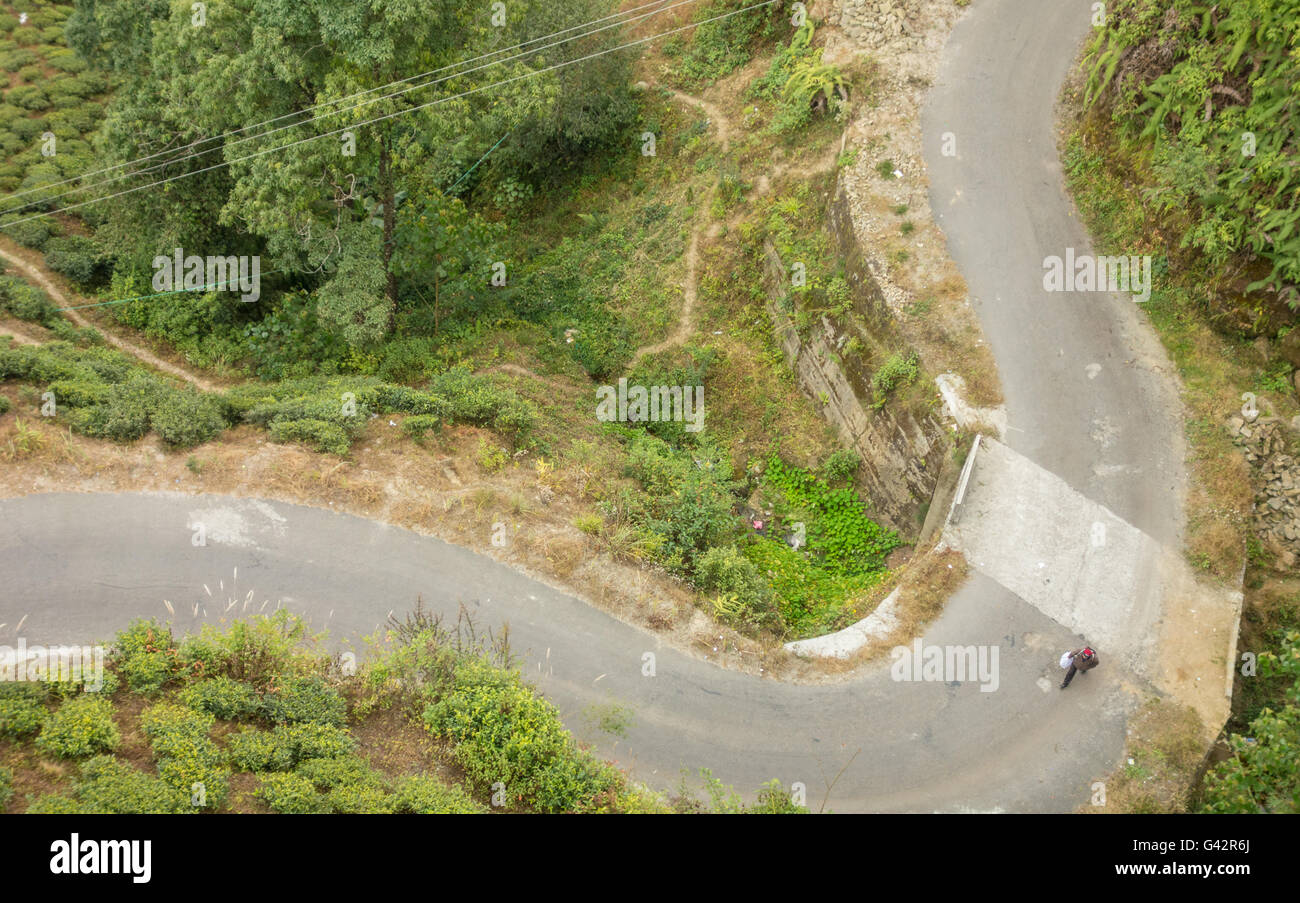 Overhead view from Darjeeling Ropeway - Lone man walking on an empty road Stock Photo