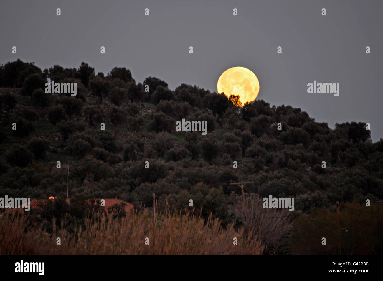 full moon above the hill at Lesvos Greece Stock Photo - Alamy