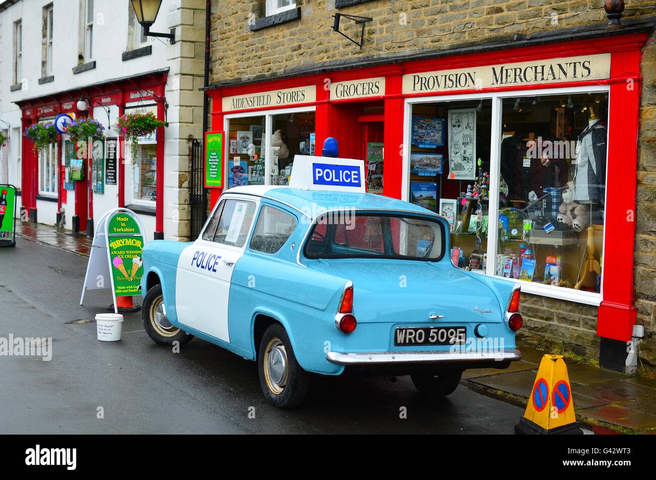 Goathland village shop in the North Yorkshire Moors with a Ford Anglia Police car. Setting ofictional village of Aidensfield Stock Photo