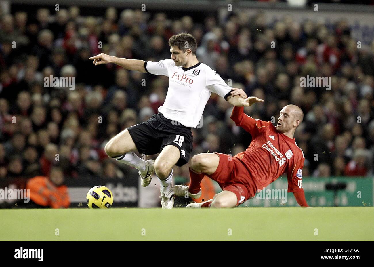 Soccer - Barclays Premier League - Liverpool v Fulham - Anfield. Fulham's Aaron Hughes (left) and Liverpool's Raul Meireles (right) Stock Photo