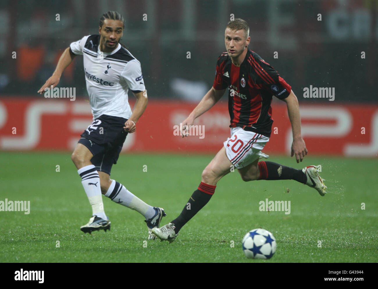 AC Milan's Ignazio Abate (right) and Tottenham Hotspurs' Benoit Assou-Ekotto during the Champions League, Round of 16, First Leg at the San Siro, Milan, Italy. Stock Photo